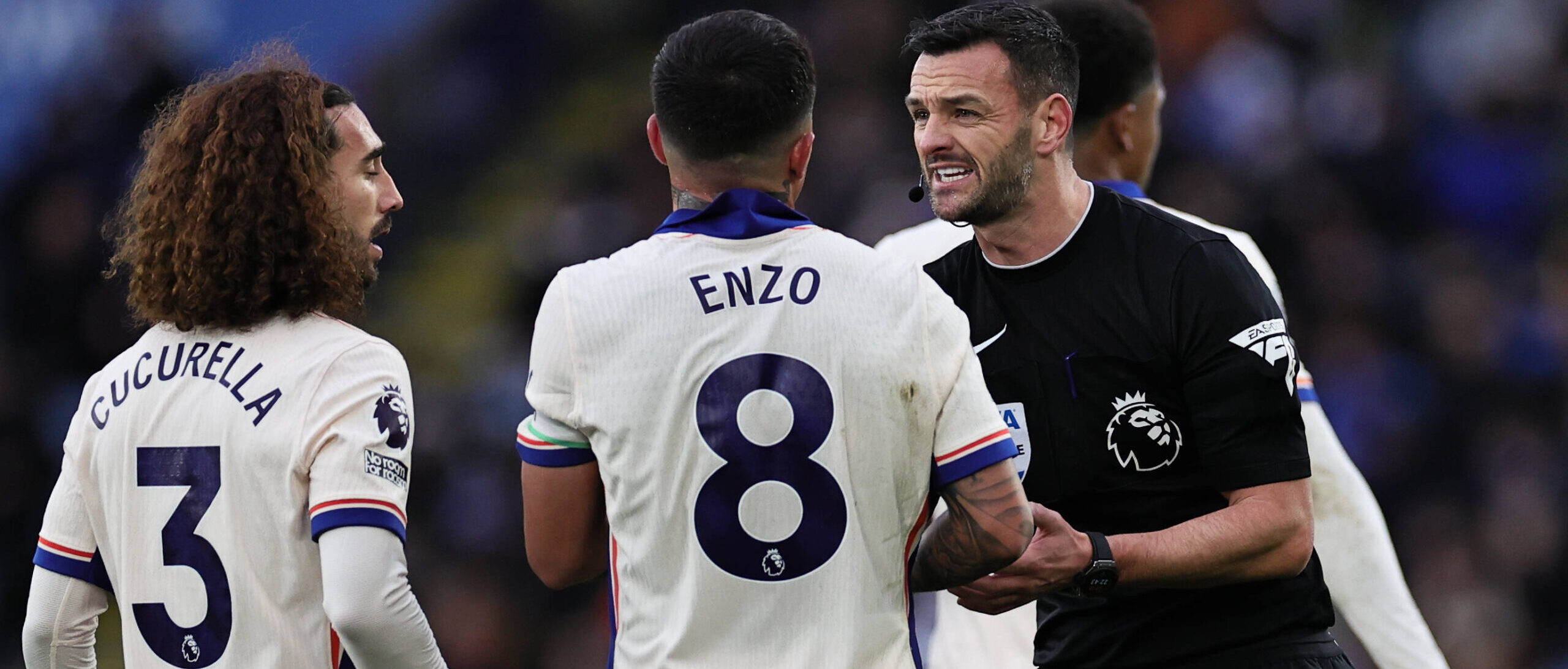 Match referee Andy Madley interacts with Enzo Fernandez of Chelsea and Marc Cucurella of Chelsea during the Premier Leag